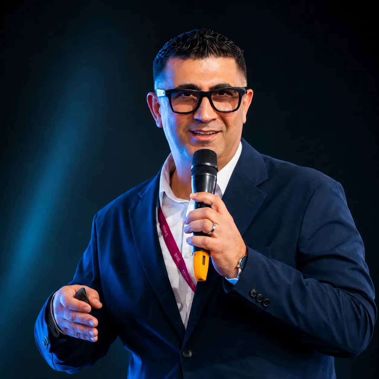 Sergey Usnunts speaking on stage with a microphone