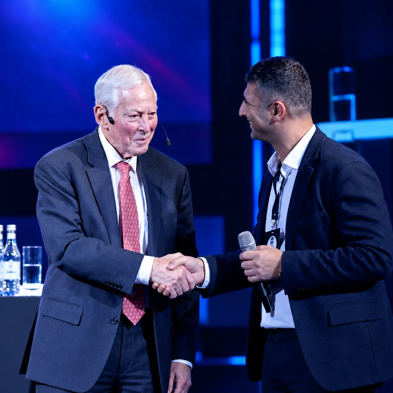 Sergey Usnunts and Brian Tracy shaking hands on stage